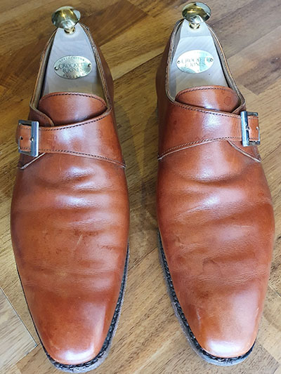 Stained pair of light tan Crockett & Jones monk shoes
